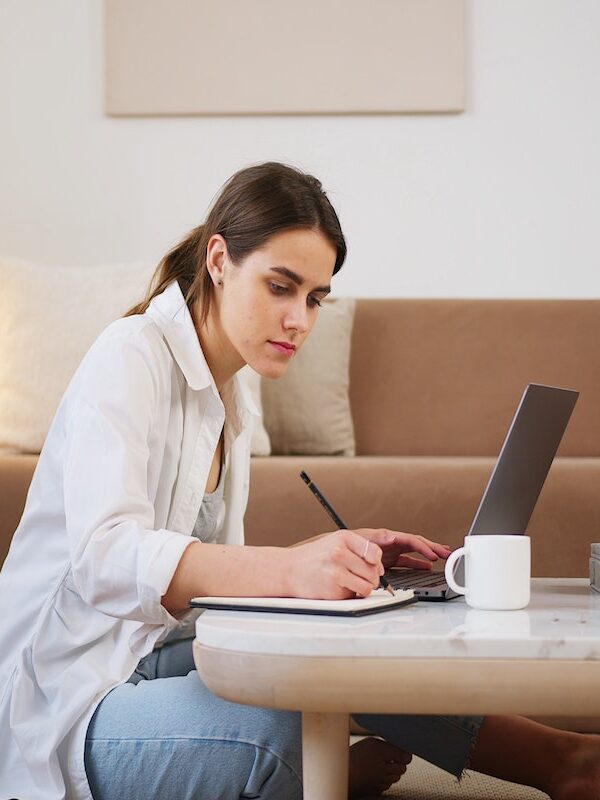 woman taking notes in living room